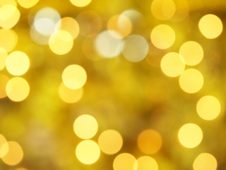 defocused yellow gold Christmas lights bokeh, blurred festive decorative lights abstract background