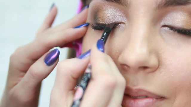 Makeup artist applying eyeshadow.