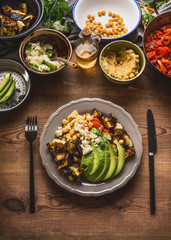 Plate with cutlery and various salad meals . Vegetarian salad bar with variety of vegetarian food bowls, top view.  Healthy eating and cooking, clean or diet food concept