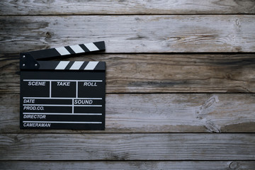 movie clapper on wood table ; film, cinema and vedio photography concept