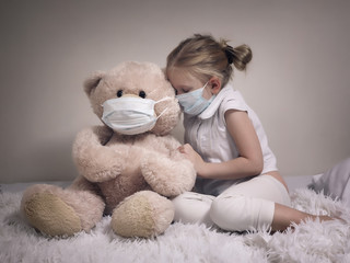 Little girl and big plush bear in medical masks. The concept of childhood diseases, empathy,...