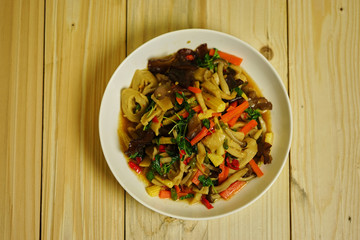 closeup vegetarian fired basil on wood table