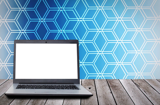laptop computer with blank screen for presentation on wooden desk and blue hexagon shape pattern background, advertising, commercial, marketing, technology, internet and business concept