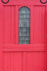 Old red wood sliding door with window in Wellfleet Cape Cod MS