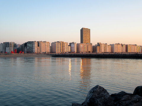 A look from the North Sea to Ostend, Belgium, sunset, reflections.