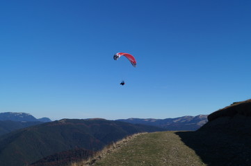 Paraglider flying over the mountains Baiului
