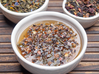 Tea of different kinds is poured into light cups.