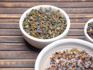 Tea of different kinds is poured into light cups.