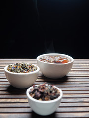 Tea of different kinds is poured into light cups.