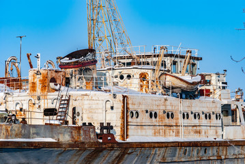 Rusty abandoned river ships