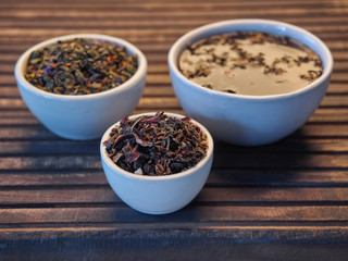 Tea of different kinds is poured into light cups.