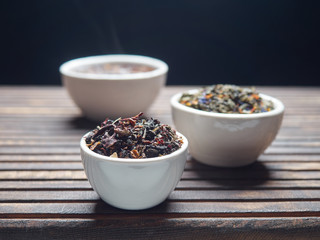 Tea of different kinds is poured into light cups.
