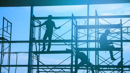 Woker silhouette on scaffold contruction contractor safty working business - obrazy, fototapety, plakaty