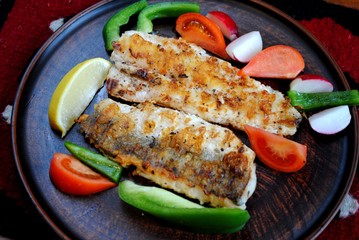 Fish hake cooked in a grill pan at home. Grilled fish
