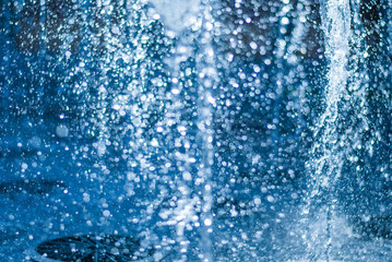 Naklejka na ściany i meble The gush of water of a fountain. Splash of water in the fountain, abstract image
