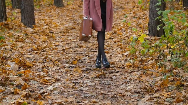 Woman Walking in the autumn park