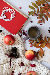 Mug of black coffee wrapped in warm scarf on wooden board. Top view, vintage style, Still life.