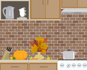 Fragment of kitchen interior on a brick wall background. There is a pan on the stove, a kettle in the picture. There is also a vase with autumn leaves, pumpkin and other vegetables and fruits. Vector 