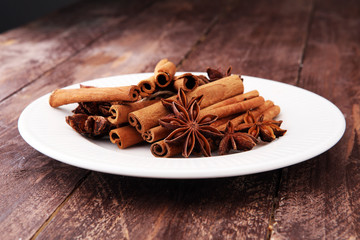 Fragrant star anise and cinnamon on wooden table.