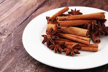 Fragrant star anise and cinnamon on wooden table.