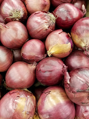 whole red onion pile at the food market