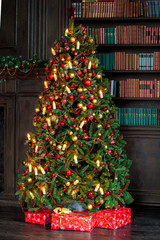 Merry christmas and new year background. Classic green tree decorated with presents under