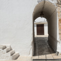Architectural detail with stairs and arch at Cisternino (Italy)