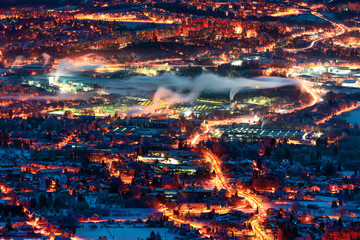 Fototapeta na wymiar City Liberec before sunrise. Snowy landscape with dark light. Jizerske hory, Bohemia, Czech republic. Snow in town.