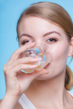 Woman drinking orange flavored drink or juice