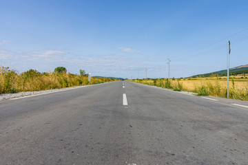 Asphalt road receding into the distance.
