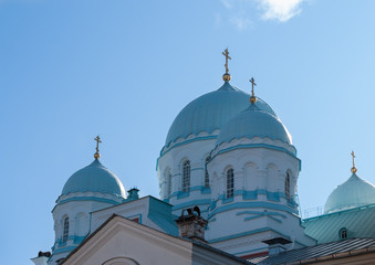 Fototapeta na wymiar Domes of an Orthodox church against a blue sky on a sunny afternoon