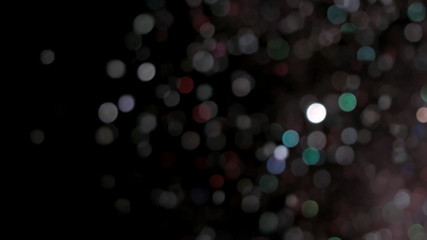 Fototapeta na wymiar Realistic Glitter Exploding on Black Background.