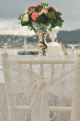 Wedding: chair and roses on the seaside background.