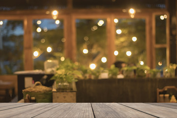 Wooden table blank in front of blurred restaurant background, used for presentation and product and text, warm circle bokeh, mock up, copy space