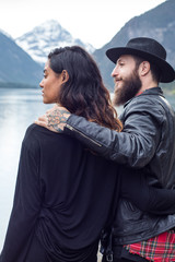 Hipster couple enjoys nature and scenic mountain lake in Austria