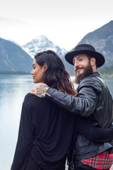 Hipster couple enjoys nature and scenic mountain lake in Austria