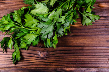 Bunch of parsley and dill on wooden table. Top view