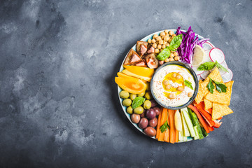 Hummus platter with assorted snacks