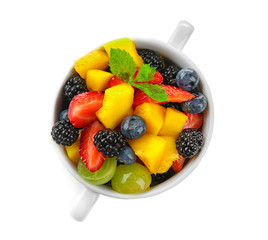 Bowl with delicious fruit salad on white background