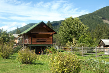 Carpathian mountains summer landscape with green hills and wooden fence, vintage hipster amazing background