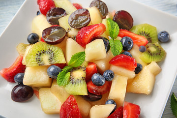 Plate with delicious fruit salad, closeup