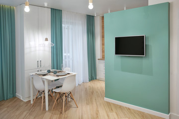 Interior of modern apartment with table served for dinner