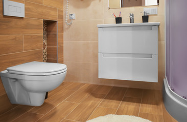 Naklejka na ściany i meble Interior of modern bathroom with toilet and sink