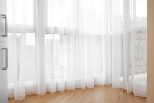 Window with beautiful curtain indoors