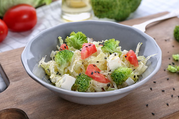 Bowl with tasty vegetable salad on table