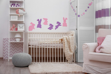 Baby bedroom with paper animals on wall