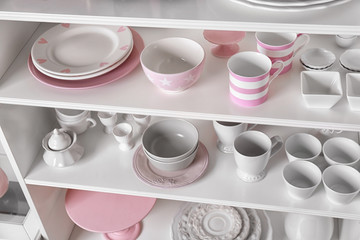 White storage stand with dishware in kitchen