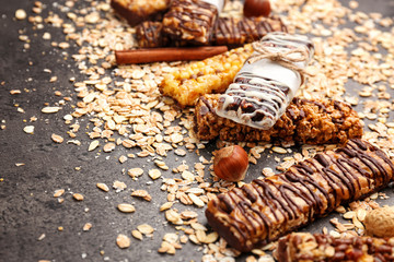 Cereal energy bars and oatmeal on table