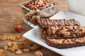 Plate with cereal energy bars on table