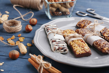 Plate with cereal energy bars on table